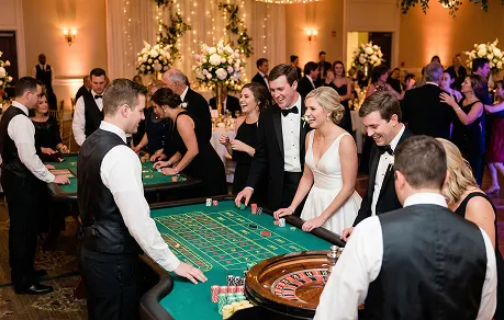 Wedding casino hire setup with roulette and blackjack tables